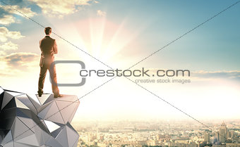 A businessman stands on an abstract construction