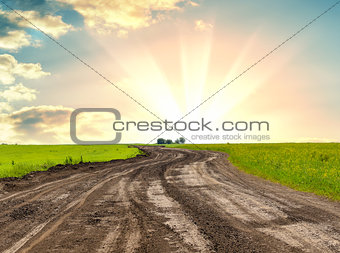 A dirt road against beautiful sunrise