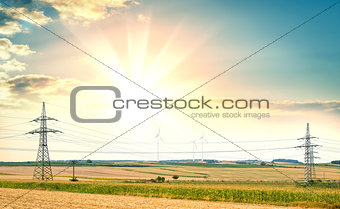 Power lines and wind farms against of sunrise