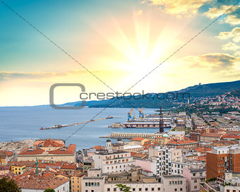 Port city against background of beautiful sunrise