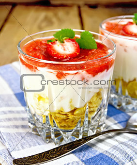 Dessert milk with strawberry in glassful on board and napkin