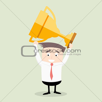 Businessman holding trophy