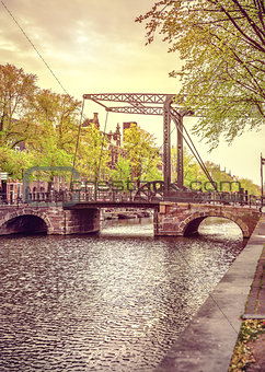 Old drawbridge in Amsterdam city over river Amstel