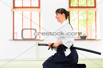 Woman at Aikido martial arts with sword