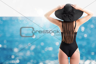 Woman with straw hat at sea