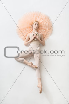 Blonde ballerina lies in studio