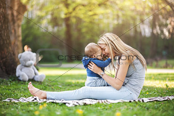 Delighted mother with her son outdoors in a park