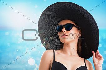 Girl with hat and sunglasses at the beach