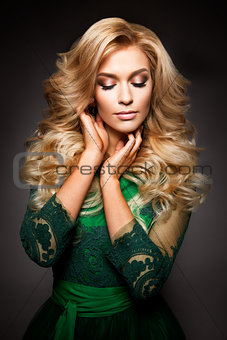 Portrait of elegant sexy blonde woman with long curly hair and glamour makeup.