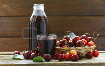 Organic cherry juice with fresh berries on the table