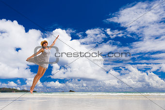 Beautiful woman jumping at the beach