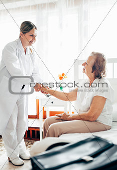 Providing care for elderly. Doctor visiting elderly patient at home. 