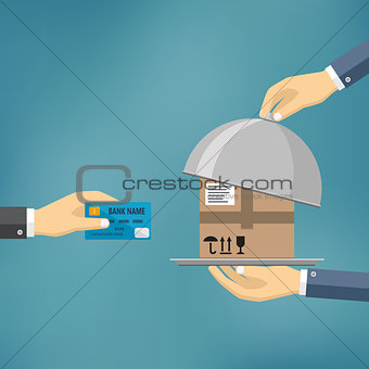 Hand with credit card and hand with parcel.