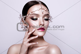Portrait of a beautiful fashion brunette bride, sweet and sensual. Wedding make up and hair. Blue eyes.