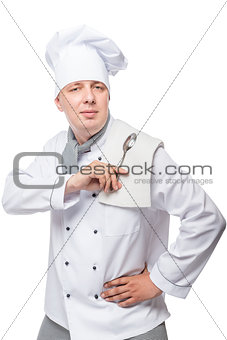 portrait of a man in the uniform of the cook with a spoon and to