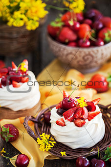 Delicious mini Pavlova meringue cake decorated with fresh berrie