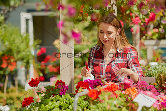 Woman spraying water on flowers