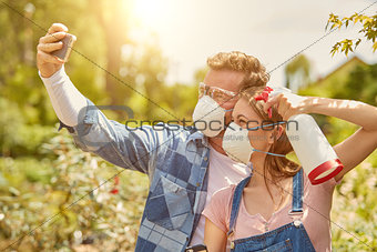 Gardeners taking selfie with respirator