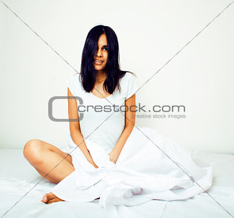 young pretty tann woman in bed among white sheets having fun, tr