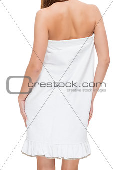 Figure of a woman in a towel view from behind on a white backgro