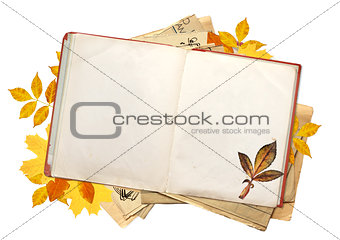 Old book with blank pages and multi-colored autumn leaves