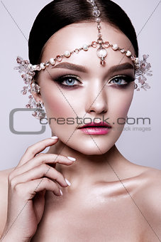 Portrait of a beautiful fashion brunette bride, sweet and sensual. Wedding make up and hair. Blue eyes.