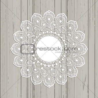 Lace style mandala on a wooden background