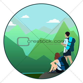 Man and woman walking on a mountain trail and looking at a horizon
