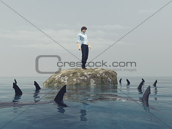 Young man on a rock in the ocean 
