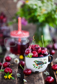 Fresh wet cherry in enamel metal mug