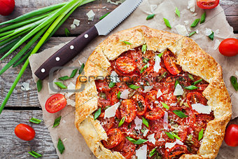 Delicious homemade rustic open pie (galette) with tomato, cheese
