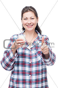 Happy woman with milk in a glass before bed on a white backgroun