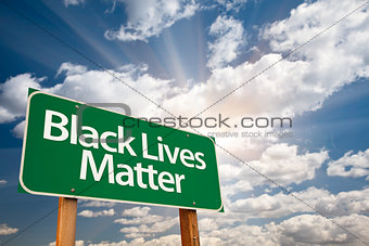 Black Lives Matter Green Road Sign with Dramatic Clouds and Sky