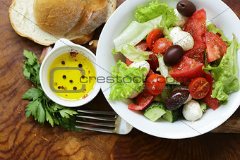 Mediterranean salad with olives, mozzarella and tomatoes