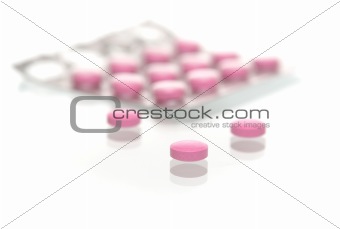 Many tablets lay in a number on a white background