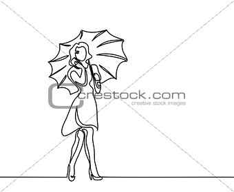 Happy woman talking by phone with umbrella