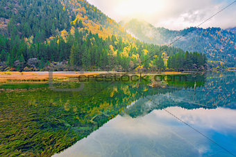 Autumn view of the lake with pure water at early morning time.