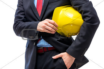 Yellow helmet in the hands of a businessman close-up