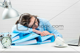 Concept - overtime in the office, tired accountant in the report
