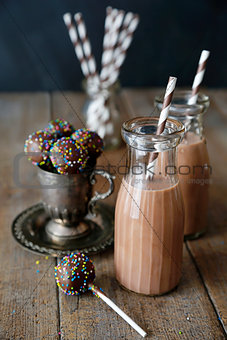 Cake pops and chocolate milk on table