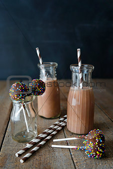 Chocolate milk with cake pops and straws