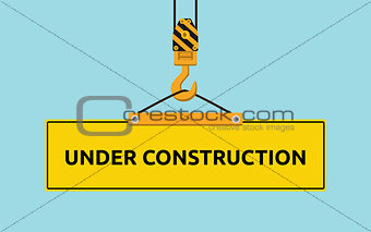 under construction signboard with crane and hook