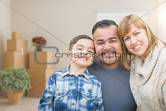 Mixed Race Family In Empty Room With Moving Boxes and Plants.