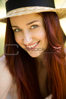 Close up portrait of sexy young lady in straw hat.