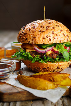 Tasty beef burger with lettuce and mustard