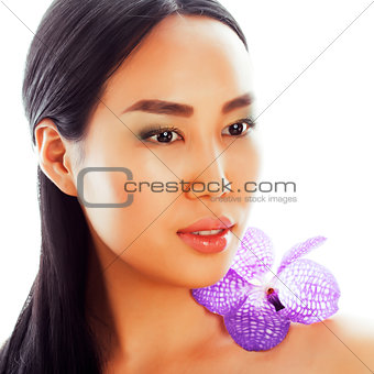 young pretty asian woman with flower purple orchid closeup isola
