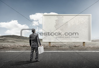 Businessman and Old Blank Billboard