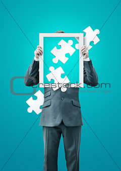 Puzzled Businessman Holding a Frame