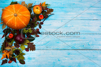 Happy Thanksgiving  greeting with fall leaves on blue wooden bac