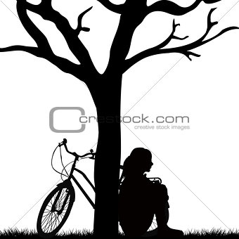Woman and bicycle leaned against a tree